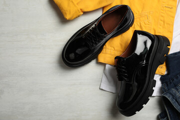 Flat lay composition with stylish female shoes on white table. Space for text