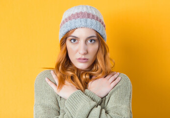 Portrait of caucasian young woman, isolated on yellow background. Pretty girl looking at camera. Head and shoulders, front view