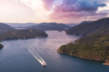 Aerial view of the Ferry traveling between the islands during a sunny summer evening. Sunset Sky Art Render. Taken in Sunshine Coast, BC, Canada.