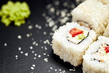 white rolls on black wooden background