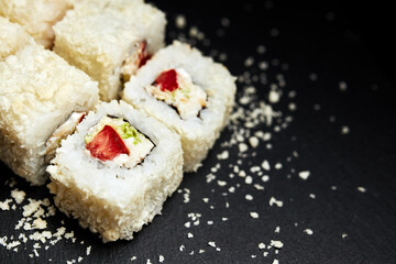 white rolls on black wooden background