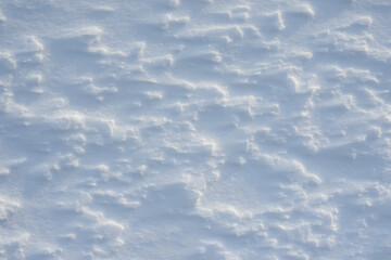Fresh clean white snow background texture. Winter background with snowflakes and snow mounds. Snow lumps. Seasonal landscape details.
