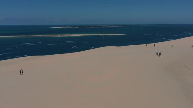  Paragliders fly over the Dune of Pilat ( Dune du Pilat ), Arcachon, France. Largest sand dune in Europe.