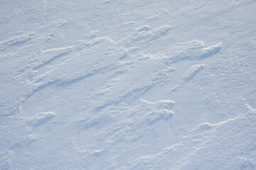 Naklejka premium Fresh clean white snow background texture. Winter background with snowflakes and snow mounds. Snow lumps. Seasonal landscape details.