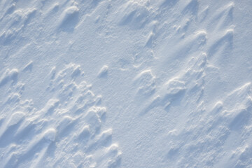 Fresh clean white snow background texture. Winter background with snowflakes and snow mounds. Snow lumps. Seasonal landscape details.