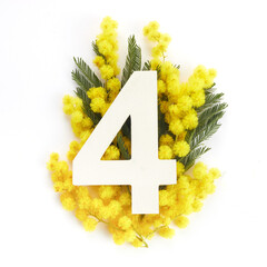 Obraz premium Layout with mimosa folwers and number four. Flat lay. Top view