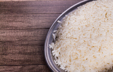 White rice served on a tray. Cooked rice popular food. Photo with food aligned to the right.
