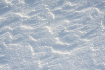 Fresh clean white snow background texture. Winter background with snowflakes and snow mounds. Snow lumps. Seasonal landscape details.