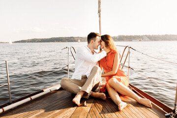 Happy couple on a yacht in the summer of celebrating honeymoon
