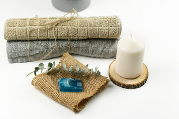 Fototapeta na wymiar Cotton towels of neutral colour lie on a table in a modern bathroom