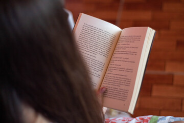 young person reading a book
