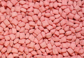 Sweets square shape, sprinkled with sugar for background. Top view.