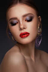 Beautiful girl with bright fashionable make-up and unusual purple accessories. Beauty face.
