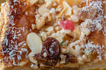 Close up of a confort food with almonds, raisin, candied fruit and sugar.