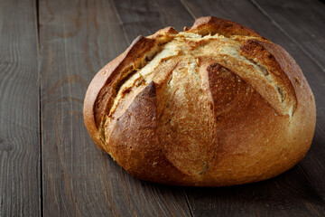 Freshly baked traditional bread on wooden table, with copy space, food closeup. Whole grain rye bread with seeds