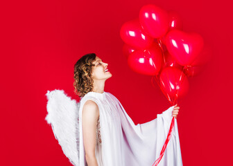 Valentines Day. Cupid angel with balloons. Female with white wings.