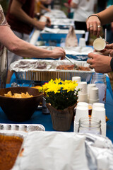 Hands getting food from a buffet line