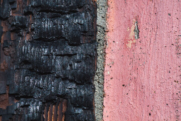 Burnt wood and cement wall.