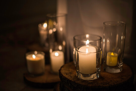 Arrangement of lit candles in glass jars.