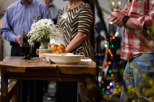 Pastor And Servers At The Communion Table Of A Contemporary Church Service 