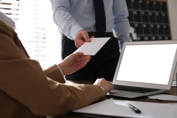 Employee giving resignation letter to boss in office, closeup - obrazy, fototapety, plakaty