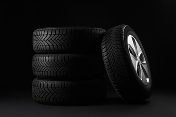 Set of wheels with winter tires on black background © New Africa