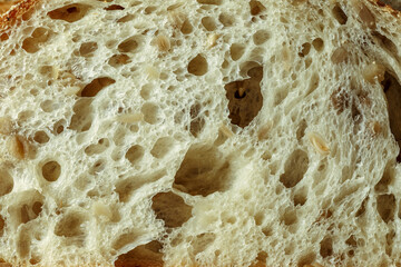 freshly baked rye bread with bran and cereal seeds: texture close-up. Healthy food.