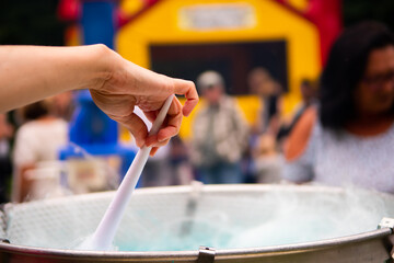 Close up of someone spinning cotton candy in a cotton candy maker