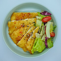 Mix salad with fried chicken and sweet chili sauce. Healthy food. Close up, top view.