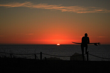 Surfer enjoying the sunset on the beach