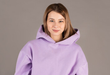 Fototapeta premium Portrait of young beautiful cute cheerful girl smiling looking at camera over gray background.