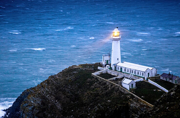 A lighthouse on South Stack, an island situated just off Holy Island on the northwest coast of...