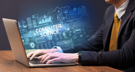 Businessman working on laptop with COMPUTER SCIENCE inscription, cyber technology concept