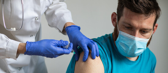 man in risk group getting coronavirus vaccine
