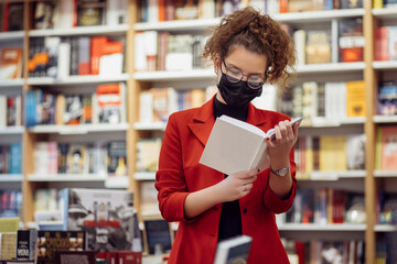 Young woman reading book. Young female student reading book at book store.