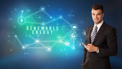 Businessman in front of cloud service icons with RENEWABLE ENERGY inscription, modern technology concept
