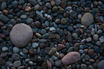 Beautiful river stones of different sizes in gray tones. Background concept.