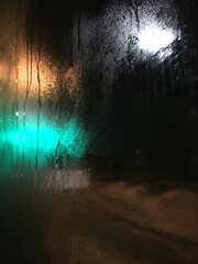 Close-up Of Wet Glass Window At Night
