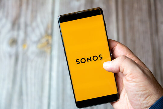 02-10-2021 Portsmouth, hampshire, UK A mobile phone or cell phone being held by a hand with the Sonos app open on screen