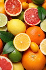Different ripe citrus fruits as background, closeup