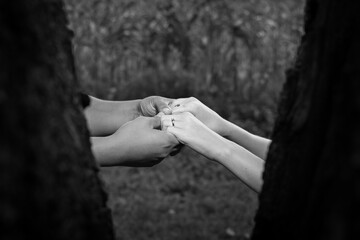 An engaged couple holding hands with focus on the ring