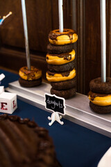 dessert Table at a Party or wedding with lost of blue and pink colors and wooden wall