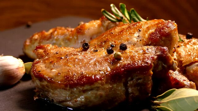 Fried pork steak on a plate. Meat dish close-up. Juicy chop.