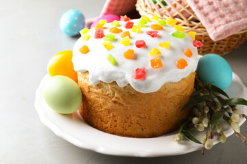 Beautiful Easter cake and painted eggs on light grey table
