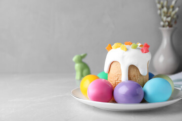 Beautiful Easter cake and painted eggs on light grey marble table. Space for text