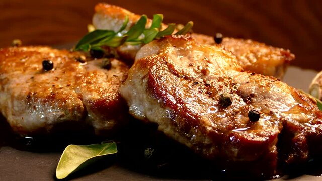 Fried pork steak on a plate. Meat dish close-up. Juicy chop.