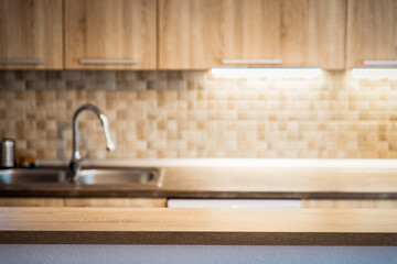 blurred kitchen interior and wooden desk space home background