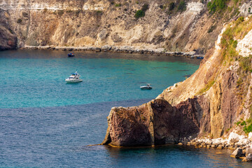 Fototapeta premium Sunny scenic blue sky landscape of rocky Black Sea coast and clear azure water viewed from Fiolent Cape in Sevastopol, Crimea, Russia.