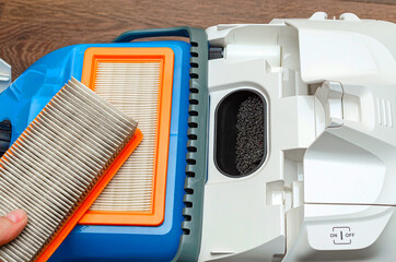 Vacuum cleaner filter with water filter. Large white vacuum cleaner on a brown floor.