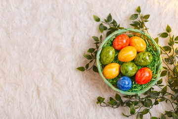 Easter card. Flat lay composition with easter eggs in a basket on white background.